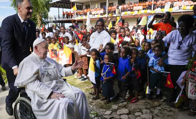 Pope Francis arrives at the Holy Trinity Humanistic School in Baro, near Vanimo, Papua New Guinea, Sunday, Sept. 8, 2024. Pope Francis celebrated the Catholic Church of the peripheries on Sunday as he traveled to the remote jungles of Papua New Guinea, bringing with him a ton of medicine and toys and a message of love overcoming violence for the people who live there.(AP Photo/Gregorio Borgia)