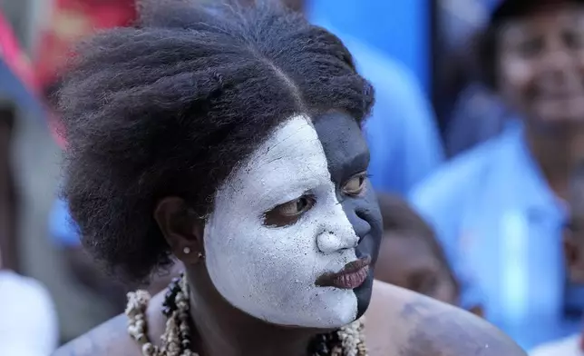 A traditional dancer waits for the arrival of Pope Francis at Caritas Technical Secondary School in Port Moresby, Papua New Guinea, Saturday, Sept. 7, 2024. (AP Photo/Mark Baker)