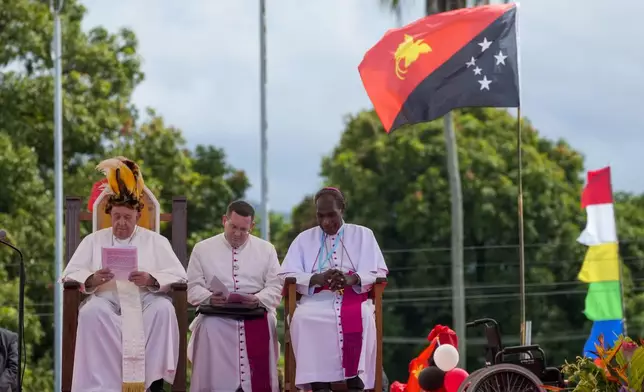 Pope Francis, left, and the Bishop of Vanimo, Francis Meli, right, attend a meeting with the faithful in Vanimo, Papua New Guinea, Sunday, Sept. 8, 2024. Pope Francis celebrated the Catholic Church of the peripheries on Sunday as he traveled to the remote jungles of Papua New Guinea, bringing with him a ton of medicine and toys and a message of love overcoming violence for the people who live there.(AP Photo/Gregorio Borgia)