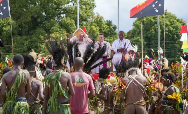 Pope Francis, with the Bishop of Vanimo Francis Meli, right, attends a meeting with faithful in Vanimo, Papua New Guinea, Sunday, Sept. 8, 2024. Pope Francis celebrated the Catholic Church of the peripheries on Sunday as he traveled to the remote jungles of Papua New Guinea, bringing with him a ton of medicine and toys and a message of love overcoming violence for the people who live there.(AP Photo/Gregorio Borgia)