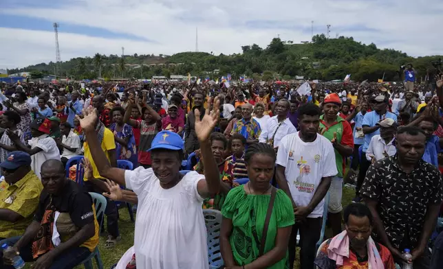 Faithful wait for Pope Francis to arrive at a meeting with faithful in Vanimo, Papua New Guinea, Sunday, Sept. 8, 2024. Pope Francis celebrated the Catholic Church of the peripheries on Sunday as he traveled to the remote jungles of Papua New Guinea, bringing with him a ton of medicine and toys and a message of love overcoming violence for the people who live there.(AP Photo/Gregorio Borgia)