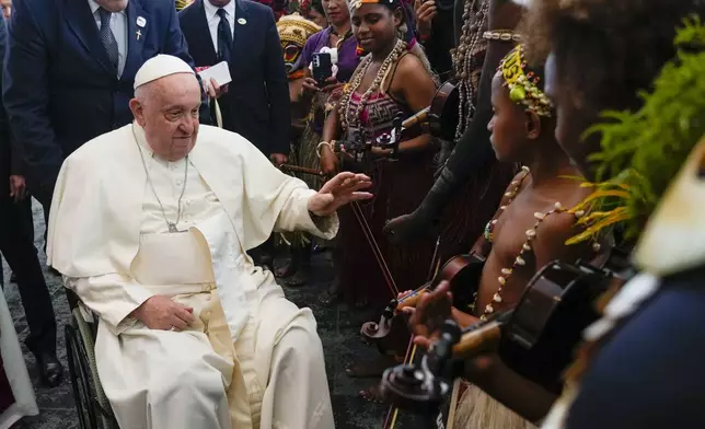 Pope Francis meets performers outside the APEC Haus in Port Moresby, Saturday, Sept. 7, 2024, where Pope Francis and Papua New Guinea's Governor General Bob Dadae attended a traditional dance performance. As a second leg of his 11-day trip to Asia and Oceania Pope Francis's visit to Papua New Guinea will take him to a remote part of the South Pacific island nation where Christianity is a recent addition to traditional spiritual beliefs developed over millennia. (AP Photo/Gregorio Borgia)