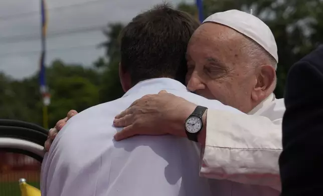 Pope Francis hugs missionary Martin Prado as they meet in Vanimo, Papua New Guinea, Sunday, Sept. 8, 2024. Pope Francis celebrated the Catholic Church of the peripheries on Sunday as he traveled to the remote jungles of Papua New Guinea, bringing with him a ton of medicine and toys and a message of love overcoming violence for the people who live there.(AP Photo/Gregorio Borgia)