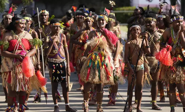 People dressed in traditional costume wait for the arrival of Pope Francis at Caritas Technical Secondary School in Port Moresby, Papua New Guinea, Saturday, Sept. 7, 2024. (AP Photo/Mark Baker)