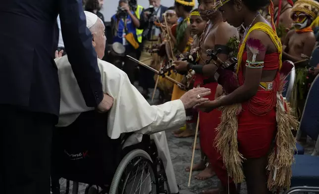 Pope Francis meets performers outside the APEC Haus in Port Moresby, Saturday, Sept. 7, 2024, where Pope Francis and Papua New Guinea's Governor General Bob Dadae attended a traditional dance performance. As a second leg of his 11-day trip to Asia and Oceania Pope Francis's visit to Papua New Guinea will take him to a remote part of the South Pacific island nation where Christianity is a recent addition to traditional spiritual beliefs developed over millennia. (AP Photo/Gregorio Borgia)