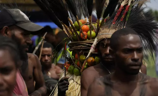 Papuan indigenous people wait for Pope Francis in Vanimo, Papua New Guinea, Sunday, Sept. 8, 2024. Pope Francis celebrated the Catholic Church of the peripheries on Sunday as he traveled to the remote jungles of Papua New Guinea, bringing with him a ton of medicine and toys and a message of love overcoming violence for the people who live there.(AP Photo/Gregorio Borgia)