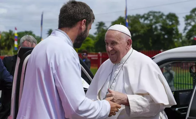 Pope Francis is greeted by Father Martin Prado, a missionary of the Institute of the Incarnate Word as he arrives in Vanimo, Papua New Guinea, Sunday, Sept. 8, 2024. . (AP Photo/Gregorio Borgia)