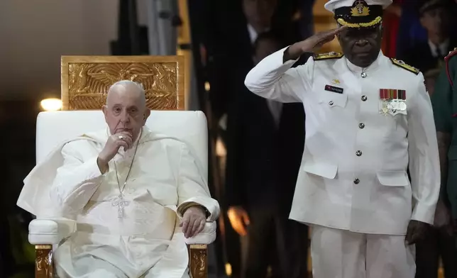 Pope Francis, left, is welcomed by rear-Admiral Philip Polewara as he arrives at Port Moresby's "Jackson" International Airport, Friday, Sept. 6, 2024. As a second leg of his 11-day trip to Asia and Oceania Pope Francis's visit to Papua New Guinea will take him to a remote part of the South Pacific island nation where Christianity is a recent addition to traditional spiritual beliefs developed over millennia.(AP Photo/Gregorio Borgia)