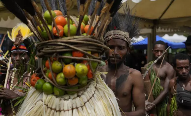 Papuan indigenous people wait for Pope Francis in Vanimo, Papua New Guinea, Sunday, Sept. 8, 2024. Pope Francis celebrated the Catholic Church of the peripheries on Sunday as he traveled to the remote jungles of Papua New Guinea, bringing with him a ton of medicine and toys and a message of love overcoming violence for the people who live there.(AP Photo/Gregorio Borgia)