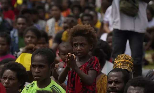 Faithful wait for Pope Francis to arrive at a meeting with faithful in Vanimo, Papua New Guinea, Sunday, Sept. 8, 2024. Pope Francis celebrated the Catholic Church of the peripheries on Sunday as he traveled to the remote jungles of Papua New Guinea, bringing with him a ton of medicine and toys and a message of love overcoming violence for the people who live there.(AP Photo/Gregorio Borgia)