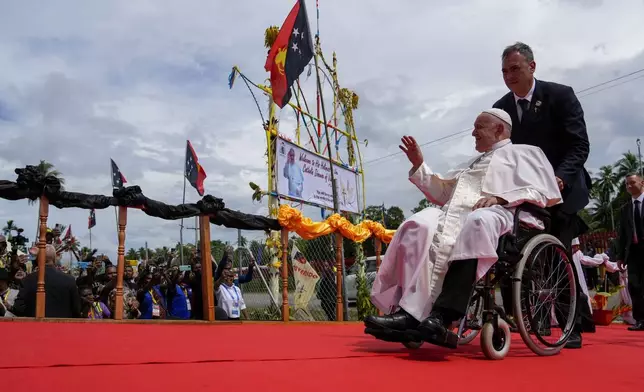 Pope Francis on a wheelchair arrives for a meeting with faithful in Vanimo, Papua New Guinea, Sunday, Sept. 8, 2024. Pope Francis celebrated the Catholic Church of the peripheries on Sunday as he traveled to the remote jungles of Papua New Guinea, bringing with him a ton of medicine and toys and a message of love overcoming violence for the people who live there.(AP Photo/Gregorio Borgia)