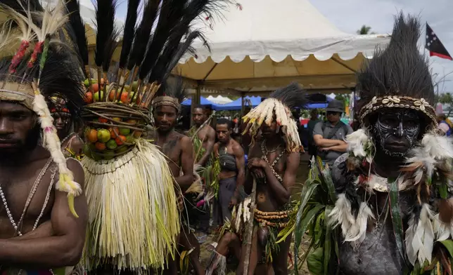 Papuan indigenous people wait for Pope Francis in Vanimo, Papua New Guinea, Sunday, Sept. 8, 2024. Pope Francis celebrated the Catholic Church of the peripheries on Sunday as he traveled to the remote jungles of Papua New Guinea, bringing with him a ton of medicine and toys and a message of love overcoming violence for the people who live there.(AP Photo/Gregorio Borgia)