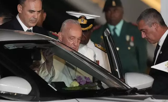 Pope Francis boards a waiting car at Jackson's International Airport in Port Moresby, Papua New Guinea, Friday, Sept. 6, 2024. (AP Photo/Mark Baker)