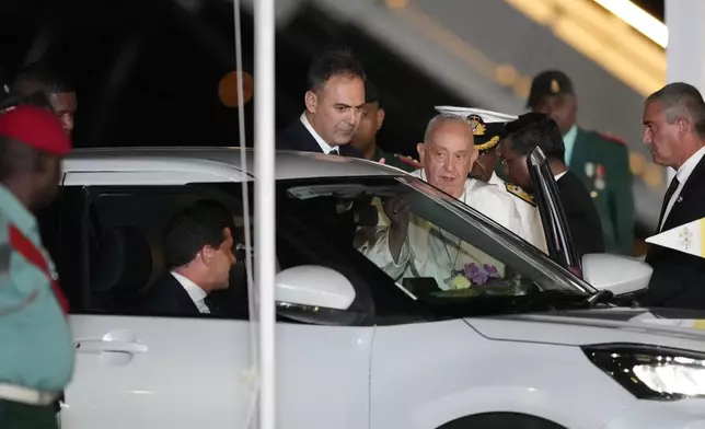 Pope Francis boards a waiting car at Jackson's International Airport in Port Moresby, Papua New Guinea, Friday, Sept. 6, 2024. (AP Photo/Mark Baker)