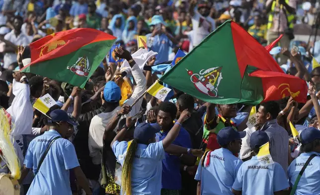 Attendees wave flags of Papua New Guinea East Sepik province during a meeting between Pope Francis and young people at the Sir John Guise stadium in Port Moresby, Monday, Sept. 9, 2024. (AP Photo/Gregorio Borgia)