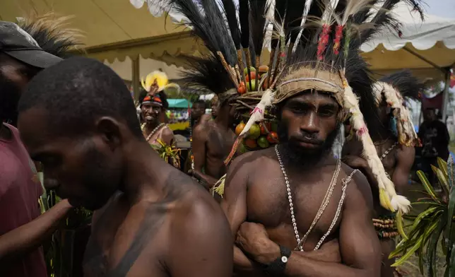 Papuan indigenous people wait for Pope Francis in Vanimo, Papua New Guinea, Sunday, Sept. 8, 2024. Pope Francis celebrated the Catholic Church of the peripheries on Sunday as he traveled to the remote jungles of Papua New Guinea, bringing with him a ton of medicine and toys and a message of love overcoming violence for the people who live there.(AP Photo/Gregorio Borgia)