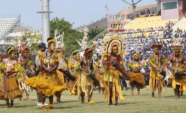 Dancers in traditional dress perform as Pope Francis gives an address during meeting with young people in the Sir John Guise Stadium in Port Moresby, Papua New Guinea, Monday, Sept. 9, 2024. (AP Photo/Mark Baker)