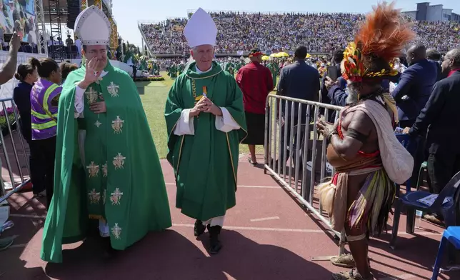 Bishops gesture as they leave a mass hosted by Pope Francis at Sir John Guise Stadium, in Port Moresby, Papua New Guinea, Sunday, Sept. 8, 2024. (AP Photo/Mark Baker)