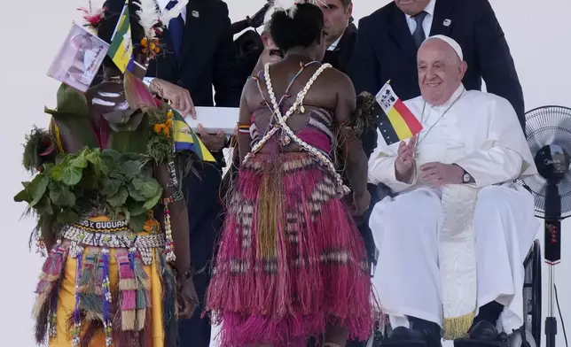 Pope Francis meets with people in traditional dress after giving an address during meeting with young people in the Sir John Guise Stadium in Port Moresby, Papua New Guinea, Monday, Sept. 9, 2024. (AP Photo/Mark Baker)