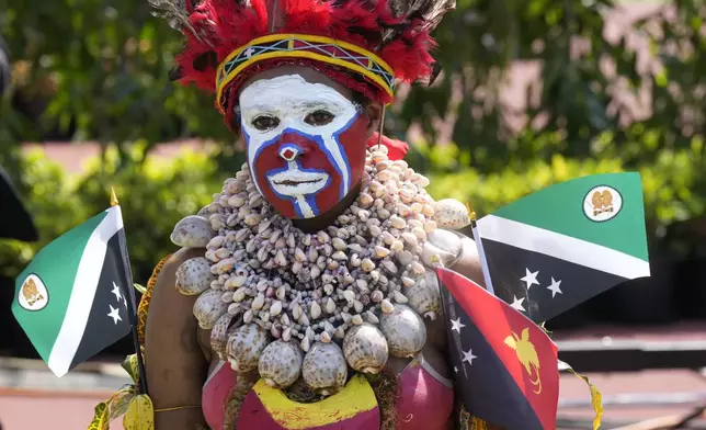 A woman in traditional dress attends an address by Pope Francis during meeting with young people in the Sir John Guise Stadium in Port Moresby, Papua New Guinea, Monday, Sept. 9, 2024. (AP Photo/Mark Baker)