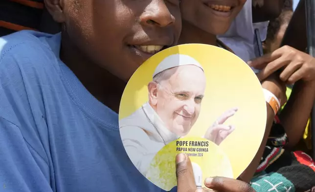 People smile as Pope Francis gives an address during meeting with young people in the Sir John Guise Stadium in Port Moresby, Papua New Guinea, Monday, Sept. 9, 2024. (AP Photo/Mark Baker)