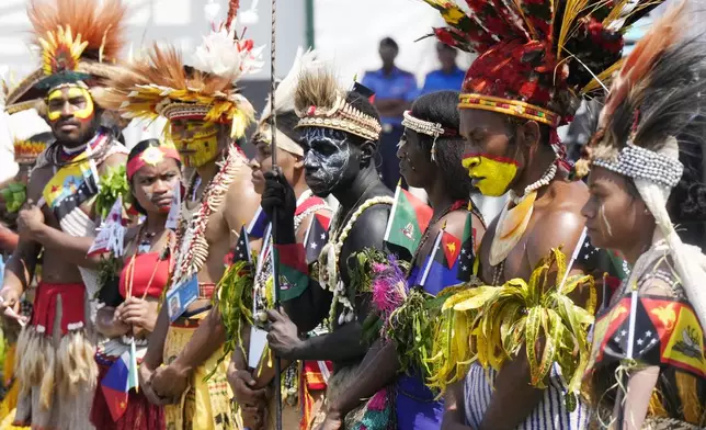 People in traditional dress stand in front of the stage as Pope Francis gives an address during meeting with young people in the Sir John Guise Stadium in Port Moresby, Papua New Guinea, Monday, Sept. 9, 2024. (AP Photo/Mark Baker)