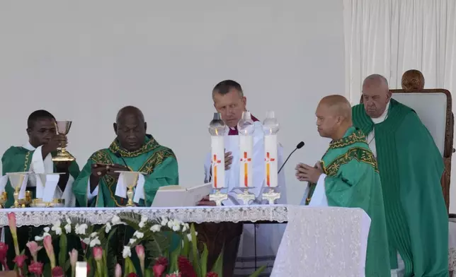 Pope Francis, right, holds a holly mass at Sir John Guise Stadium in Port Moresby, Papua New Guinea, Sunday, Sept. 8, 2024. (AP Photo/Mark Baker)