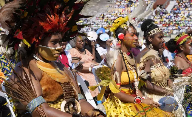 Women in traditional dress attend as Pope Francis holds a holly mass at Sir John Guise Stadium in Port Moresby, Papua New Guinea, Sunday, Sept. 8, 2024. (AP Photo/Mark Baker)