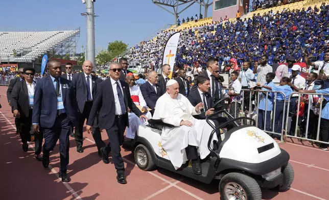 Pope Francis arrives in a cart to give an address during meeting with young people in the Sir John Guise Stadium in Port Moresby, Papua New Guinea, Monday, Sept. 9, 2024. (AP Photo/Mark Baker)