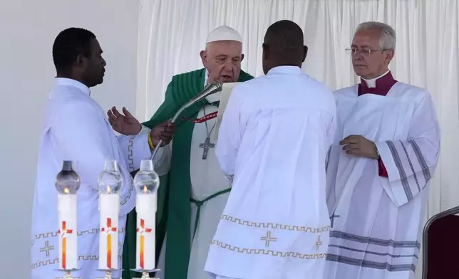 Pope Francis, second left, holds a holly mass at Sir John Guise Stadium in Port Moresby, Papua New Guinea, Sunday, Sept. 8, 2024. (AP Photo/Mark Baker)