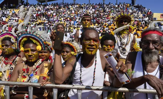 People attend as Pope Francis holds a holly mass at Sir John Guise Stadium in Port Moresby, Papua New Guinea, Sunday, Sept. 8, 2024. (AP Photo/Mark Baker)