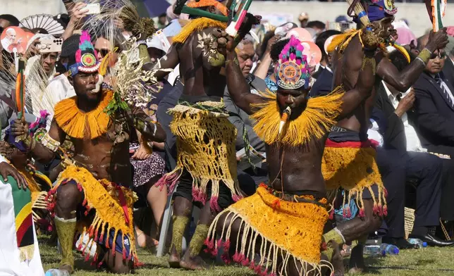 Dancers in traditional dress perform as Pope Francis holds a holly mass at Sir John Guise Stadium in Port Moresby, Papua New Guinea, Sunday, Sept. 8, 2024. (AP Photo/Mark Baker)