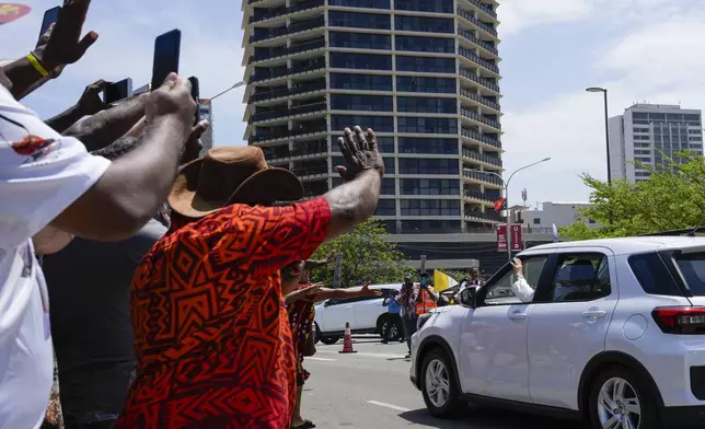 Locals wave as Pope Francis leaves APEC Haus in Port Moresby, Papua New Guinea, Saturday, Sept. 7, 2024. (AP Photo/Mark Baker)