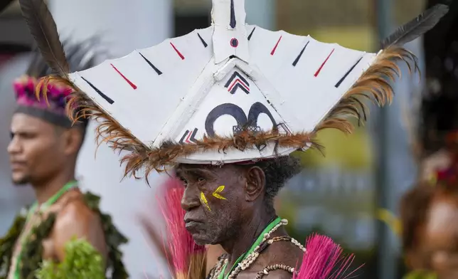 A traditional dancer waits for the arrival of Pope Francis at APEC Haus in Port Moresby, Papua New Guinea, Saturday, Sept. 7, 2024. (AP Photo/Mark Baker)