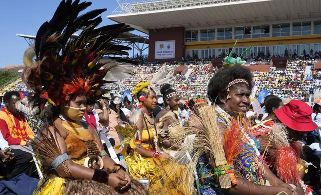 Women in traditional dress attend as Pope Francis holds a holly mass at Sir John Guise Stadium in Port Moresby, Papua New Guinea, Sunday, Sept. 8, 2024. (AP Photo/Mark Baker)