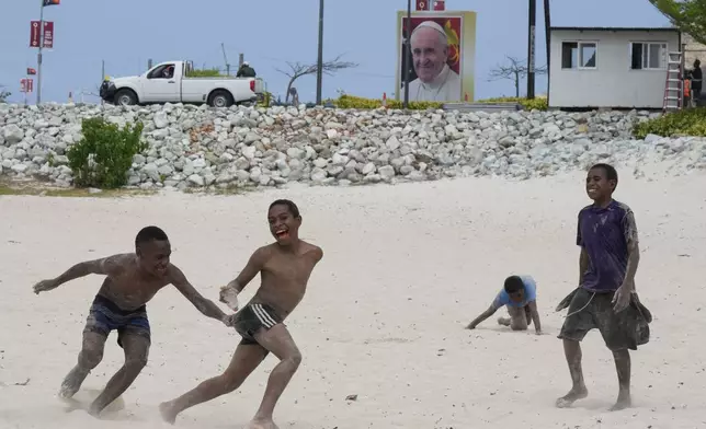 Children play on a beach near a venue where Pope Francis will visit later this week in Port Moresby, Papua New Guinea, Thursday, Sept. 5, 2024. (AP Photo/Mark Baker)