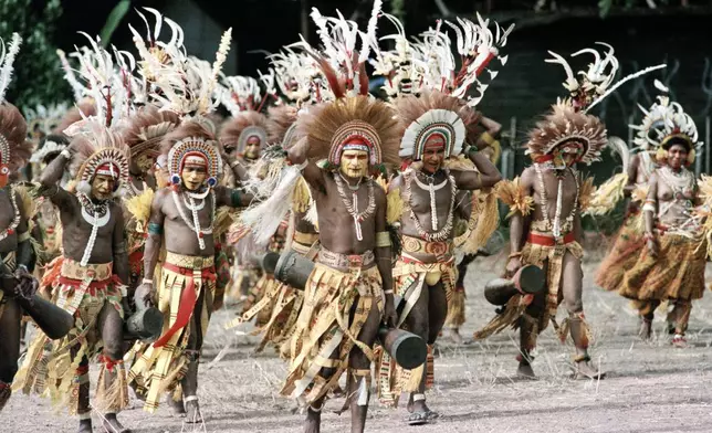 FILE - Painted warriors practice their performance on May 6, 1984, in Port Moresby, Papua New Guinea, before the arrival of Pope John Paul II. (AP Photo/Jeff Widener, File)