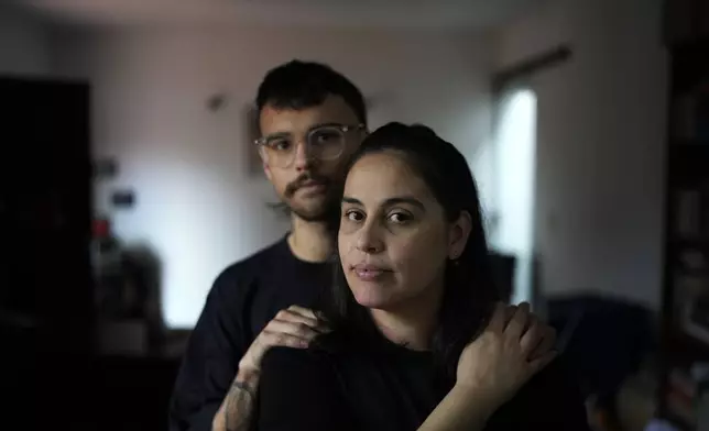 Diana Zalazar and her son Ato Martino pose for a portrait at their home in Asuncion, Paraguay, Friday, Aug. 23, 2024. Zalazar said she got pregnant after having sex with her first partner when she was 14 years old but that no one had talked to her about the risks of pregnancy or sexually transmitted diseases. (AP Photo/Jorge Saenz)