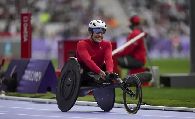 Switzerland's Catherine Debrunner celebrates after winning the women's 1500 m. T54 during the 2024 Paralympics, Tuesday, Sept. 3, 2024, in Paris, France. (AP Photo/Thibault Camus)