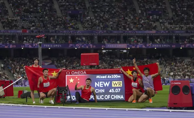 China team poses after winning the gold and setting a new world record in the 4x100 m. universal relay at the 2024 Paralympics, Friday, Sept. 6, 2024, in Paris, France. (AP Photo/Thibault Camus)