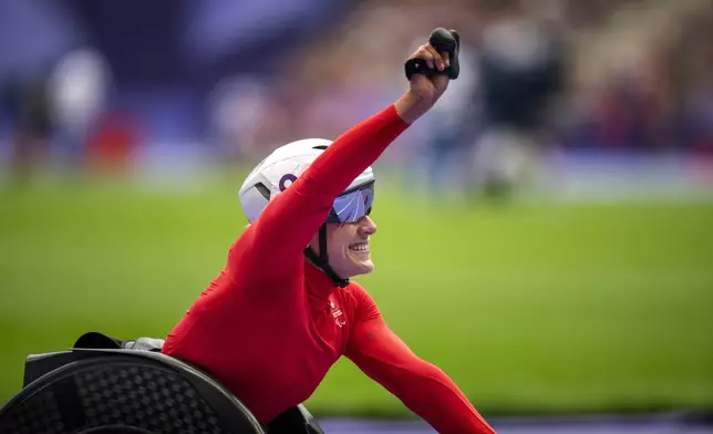 Catherine Debrunner, of Switzerland, celebrates after winning at Women's 5000m - T54 final at the Stade de France stadium, during the 2024 Paralympics, Saturday, Aug. 31, 2024, in Paris, France. (AP Photo/Emilio Morenatti)