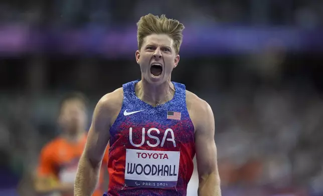 Hunter Woodhall from the U.S. celebrates after winning the men's 400 m. T62 final at the 2024 Paralympics, Friday, Sept. 6, 2024, in Paris, France. (AP Photo/Thibault Camus)