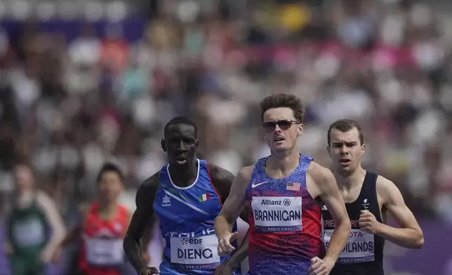 Michael Brannigan of the U.S, center, Britain's Ben Sandilands, right, and Italy's Ndiaga Dieng, left, compete in the men's 1500m T20 final during the 2024 Paralympics, Friday, Sept. 6, 2024, in Paris, France. (AP Photo/Thibault Camus)