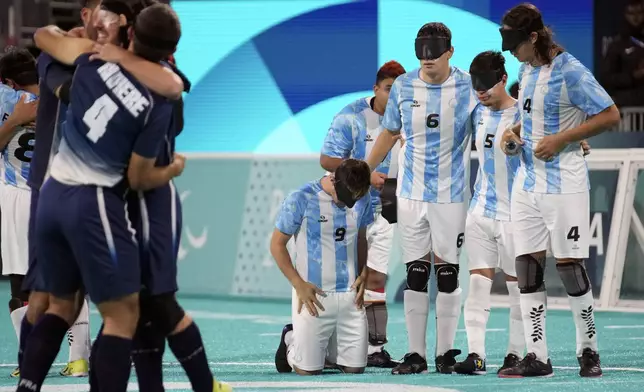 Argentina players look dejected after losing the blind football gold medal match at the 2024 Paralympics, Saturday, Sept. 7, 2024, in Paris, France. (AP Photo/Christophe Ena)