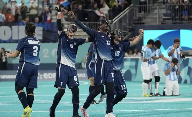 France players celebrate winning the blind football gold medal match at the 2024 Paralympics, Saturday, Sept. 7, 2024, in Paris, France. (AP Photo/Christophe Ena)