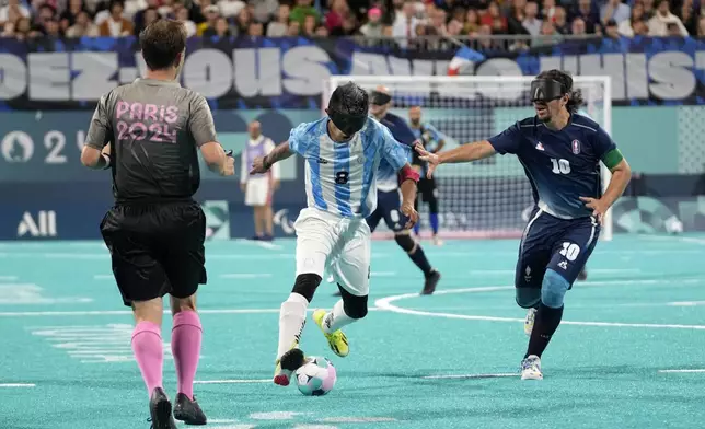 Argentina's Osvaldo Fernandez and France's Frederic Villeroux, right, fight for the ball during the blind football gold medal match at the 2024 Paralympics, Saturday, Sept. 7, 2024, in Paris, France. (AP Photo/Christophe Ena)