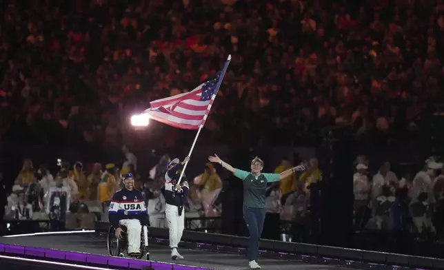 Members of the United States delegation parade during the closing ceremony of the 2024 Paralympics, Sunday, Sept. 8, 2024, in Paris, France. (AP Photo/Thibault Camus)