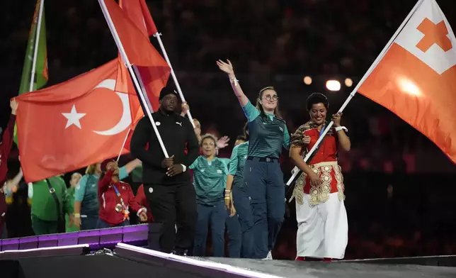 Athletes from different delegations parade during the closing ceremony of the 2024 Paralympics, Sunday, Sept. 8, 2024, in Paris, France. (AP Photo/Michel Euler)