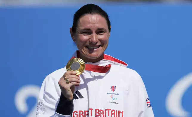 Britain's Sarah Storey celebrates with her gold medal after winning the women's C4-5 road race during the 2024 Paralympics, Friday, Sept. 6, 2024, in Clichy-sous-Bois, France. (AP Photo/Aurelien Morissard)