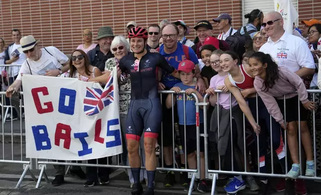 Britain's Sarah Storey celebrates with fans after winning the gold medal in the women's C4-5 road race during the 2024 Paralympics, Friday, Sept. 6, 2024, in Clichy-sous-Bois, France. (AP Photo/Aurelien Morissard)